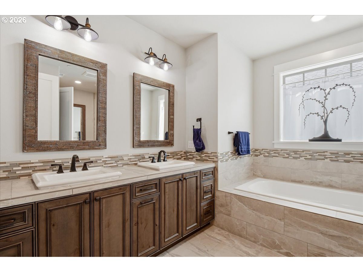 4026 Northwest 75th Avenue, Unit 70 Camas, WA 98607 - Photo 21 of 47 a bathroom with a tub a sink and mirror