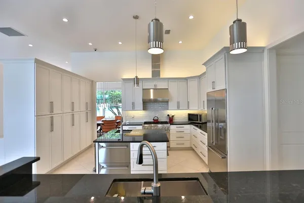 a view of kitchen with refrigerator and window