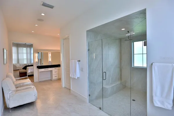 a bathroom with a granite countertop sink a toilet and shower