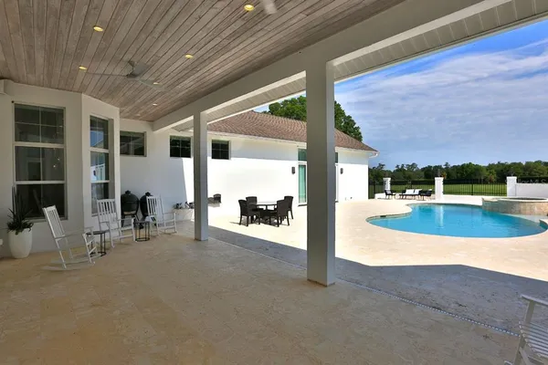 a view of a swimming pool with outdoor seating