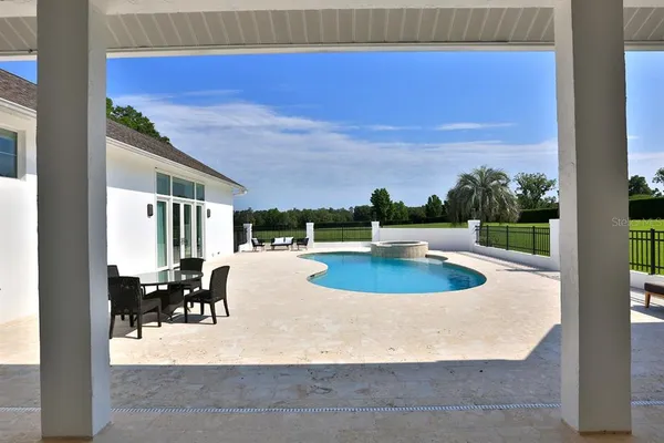 a view of a swimming pool with a lounge chair