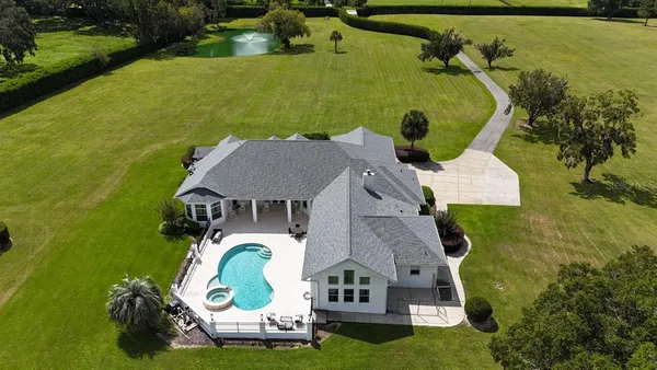 an aerial view of a house with garden space and street view