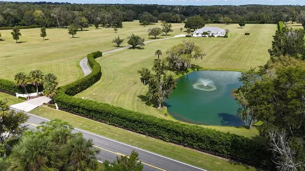 an aerial view of a house with a swimming pool