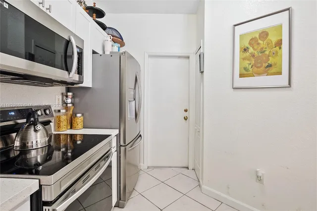 a kitchen with stainless steel appliances a refrigerator and a stove top oven