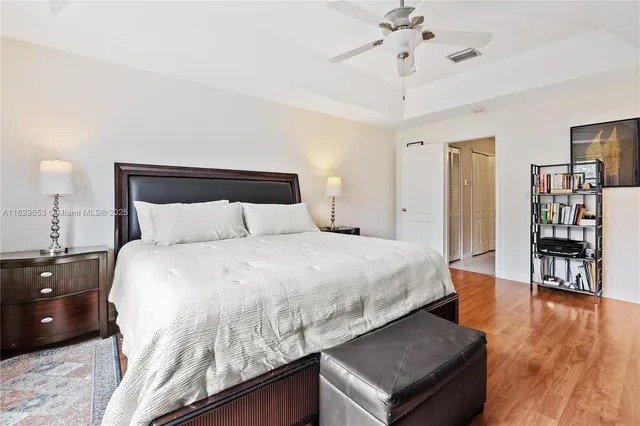 a bedroom with a large bed and a chandelier