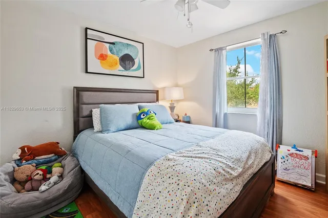 a bedroom with bed and painting on the wall