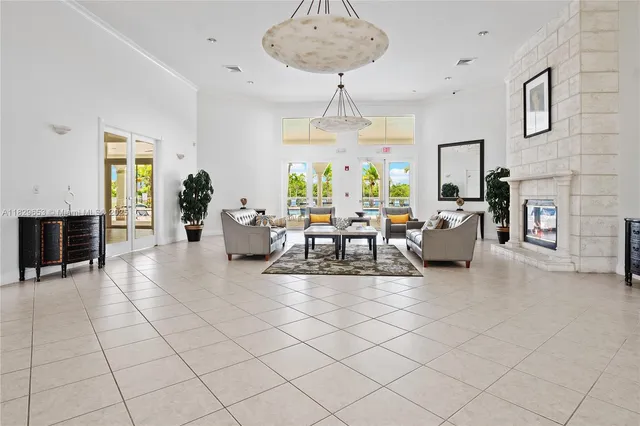 a living room with fireplace furniture and a chandelier