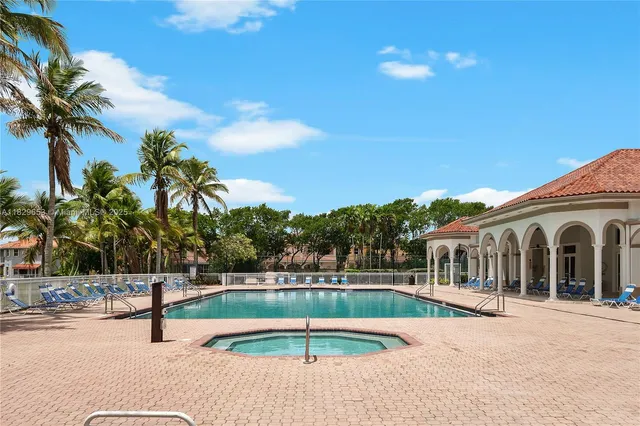 a view of house with swimming pool and sitting area