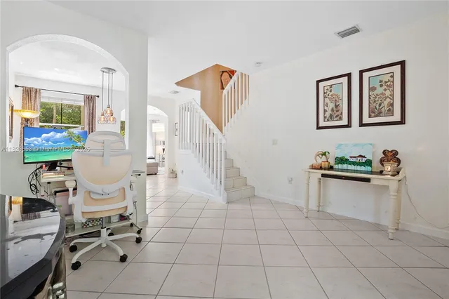 a living room with furniture a rug and white walls