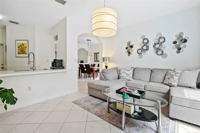 a living room with furniture and a large mirror