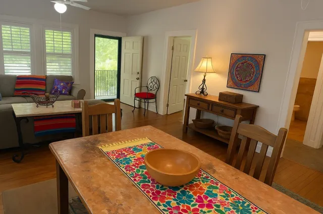 a living room with furniture and wooden floor