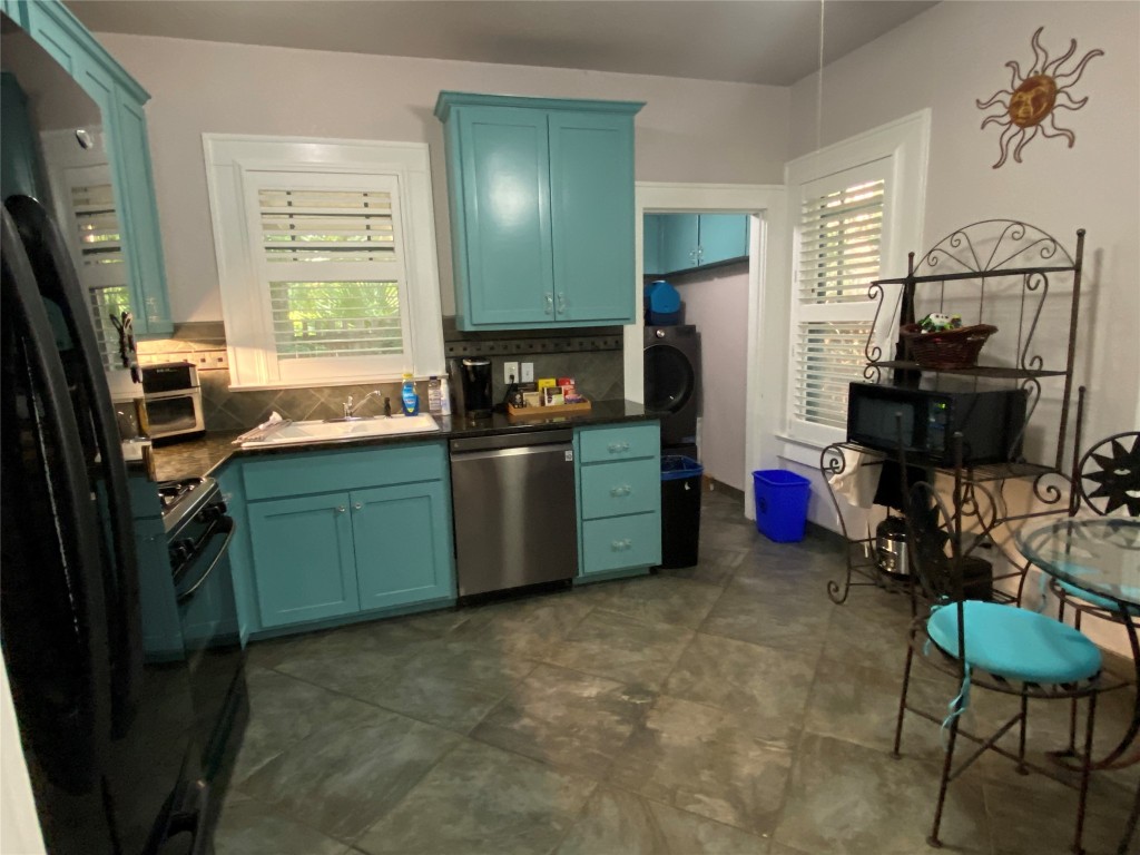 3101 Wheeler Street Austin, TX 78705 - Photo 2 of 16 a kitchen that has a sink a window and stainless steel appliances