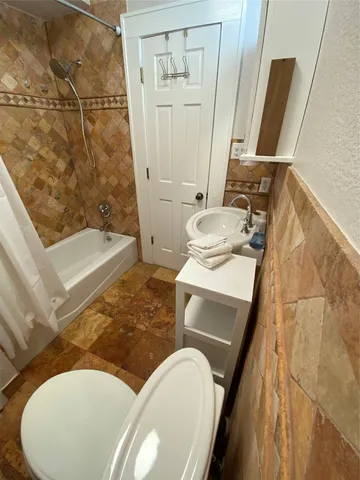 a living room with chairs and a table