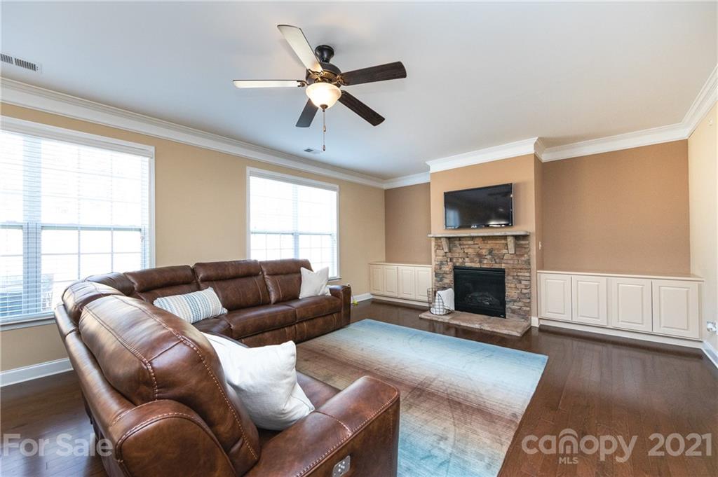 281 Annatto Way Tega Cay, SC 29708 - Photo 12 of 48 a living room with furniture a fireplace and a flat screen tv