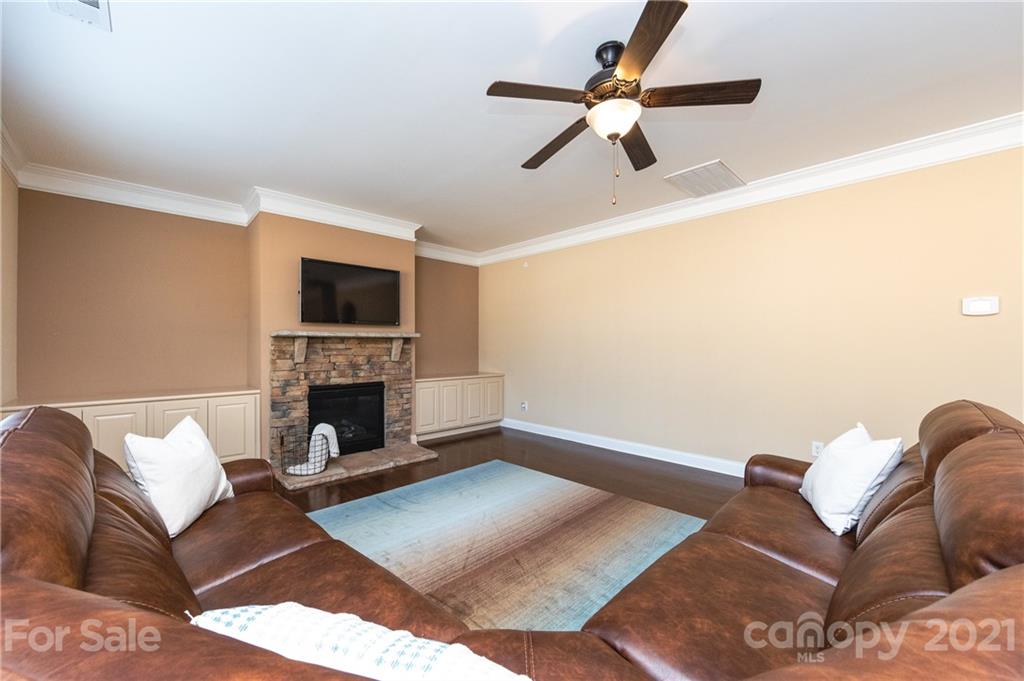 281 Annatto Way Tega Cay, SC 29708 - Photo 13 of 48 a living room with furniture a fireplace and a flat screen tv