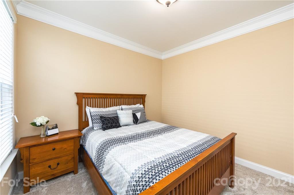 281 Annatto Way Tega Cay, SC 29708 - Photo 20 of 48 a bedroom with a bed and a window