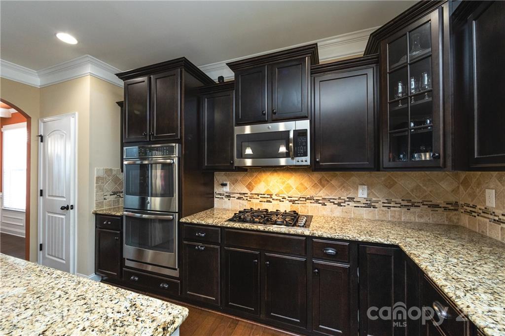 281 Annatto Way Tega Cay, SC 29708 - Photo 3 of 48 a kitchen with stainless steel appliances granite countertop a refrigerator and a sink