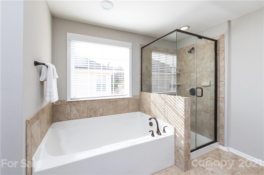 281 Annatto Way Tega Cay, SC 29708 - Photo 29 of 48 a bathroom with a bathtub and shower