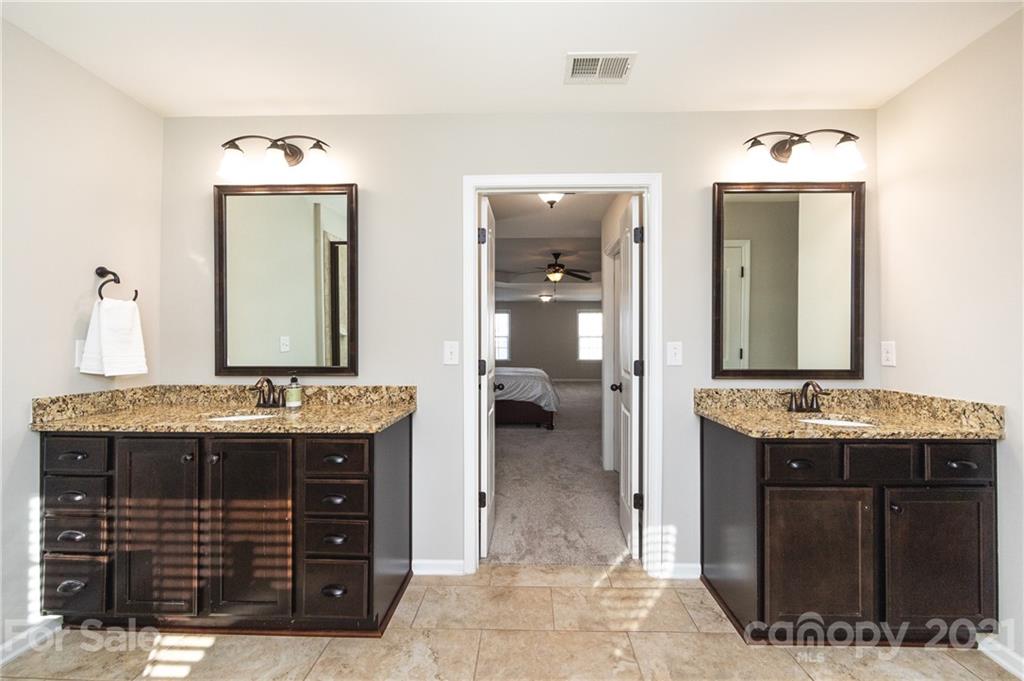 281 Annatto Way Tega Cay, SC 29708 - Photo 30 of 48 a bathroom with a granite countertop sink and a mirror