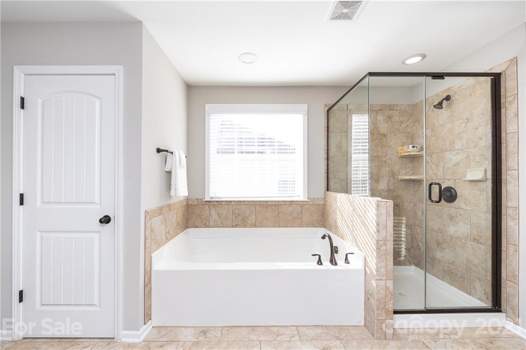 281 Annatto Way Tega Cay, SC 29708 - Photo 31 of 48 a bathroom with a bathtub and shower