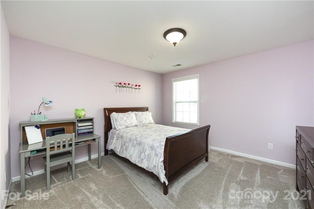 281 Annatto Way Tega Cay, SC 29708 - Photo 32 of 48 a bedroom with a bed and a desk