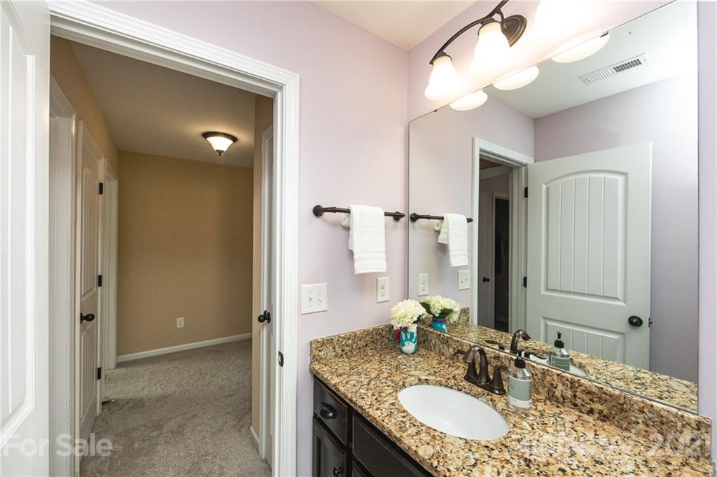 281 Annatto Way Tega Cay, SC 29708 - Photo 33 of 48 a bathroom with a granite countertop double vanity sink and a mirror