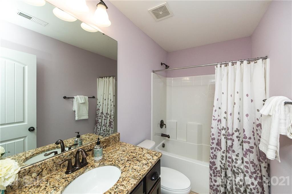 281 Annatto Way Tega Cay, SC 29708 - Photo 34 of 48 a bathroom with a granite countertop sink toilet and shower