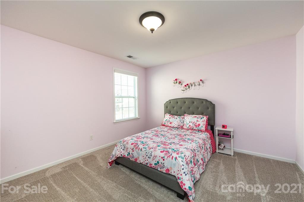 281 Annatto Way Tega Cay, SC 29708 - Photo 35 of 48 a bedroom with a bed and a window