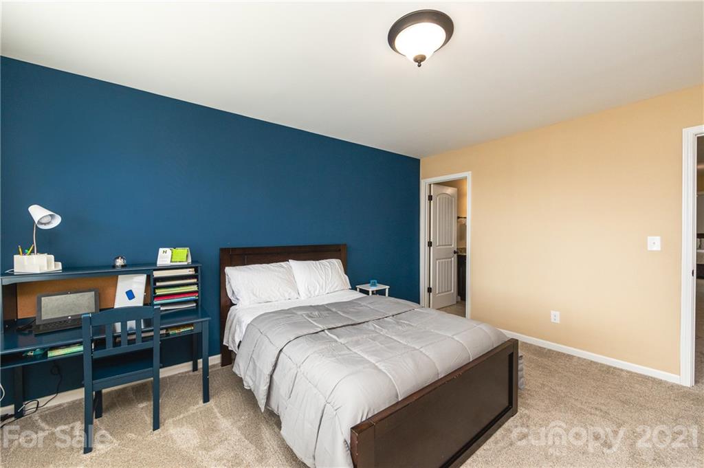 281 Annatto Way Tega Cay, SC 29708 - Photo 37 of 48 a bedroom with a bed and a lamp on dresser
