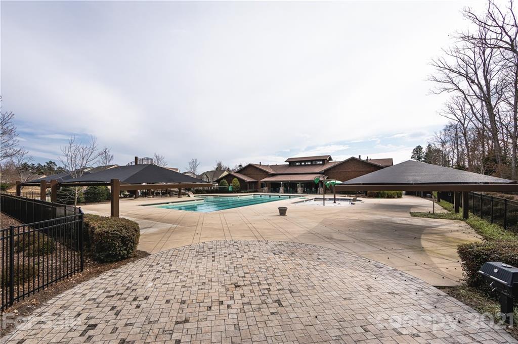 281 Annatto Way Tega Cay, SC 29708 - Photo 47 of 48 a patio with a table and chairs under an umbrella