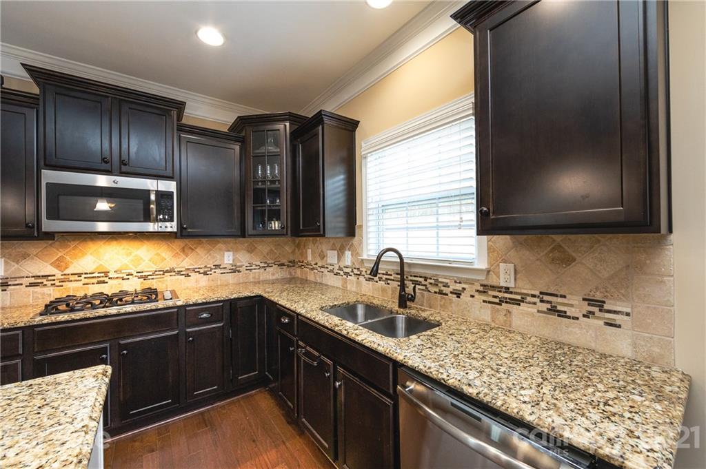 281 Annatto Way Tega Cay, SC 29708 - Photo 6 of 48 a kitchen with stainless steel appliances granite countertop sink stove and cabinets