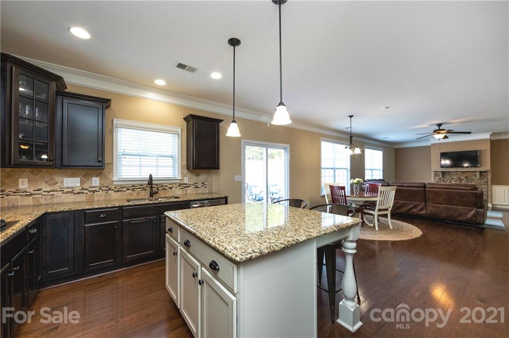 281 Annatto Way Tega Cay, SC 29708 - Photo 7 of 48 a kitchen with center island table and chairs
