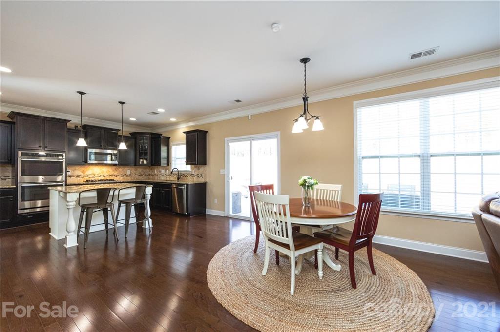 281 Annatto Way Tega Cay, SC 29708 - Photo 9 of 48 a dining room with furniture window and wooden floor