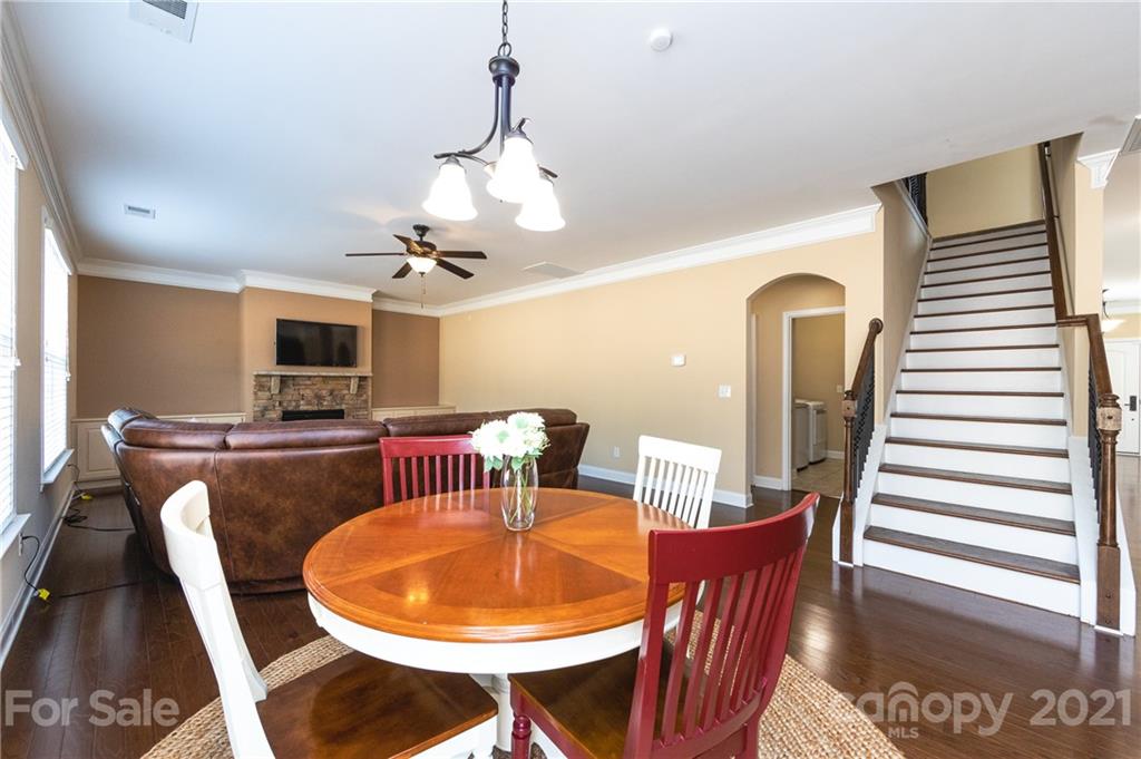281 Annatto Way Tega Cay, SC 29708 - Photo 10 of 48 a dining room with furniture a chandelier and wooden floor