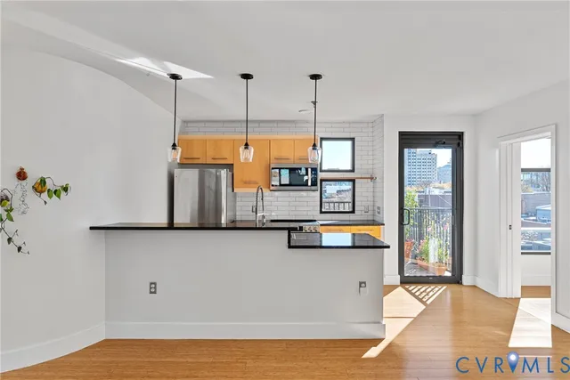 a kitchen with granite countertop a stove a refrigerator and a oven