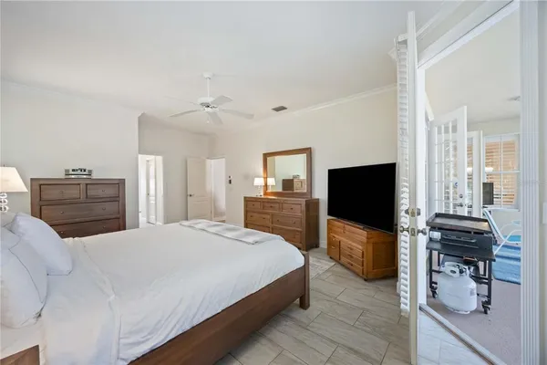 a bedroom with a bed and a flat screen tv