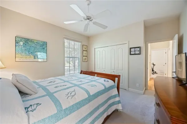 a bedroom with a bed couch and a window