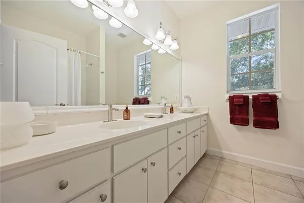 a bathroom with a double vanity sink mirror and
