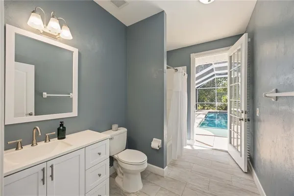 a bathroom with a toilet a sink a vanity and mirror