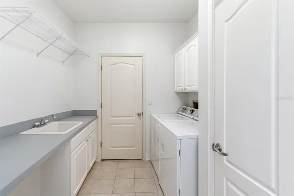 a utility room with a sink a washer and dryer