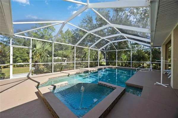a view of a living room and dining room with a floor to ceiling window