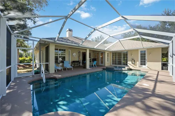 a view of a house with backyard porch and sitting area