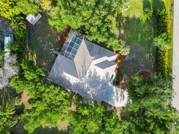 an aerial view of a house with a yard and garden
