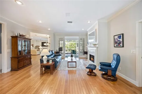a living room with furniture and a dining table with kitchen view