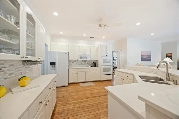 a large kitchen with stainless steel appliances lots of counter top space and cabinets