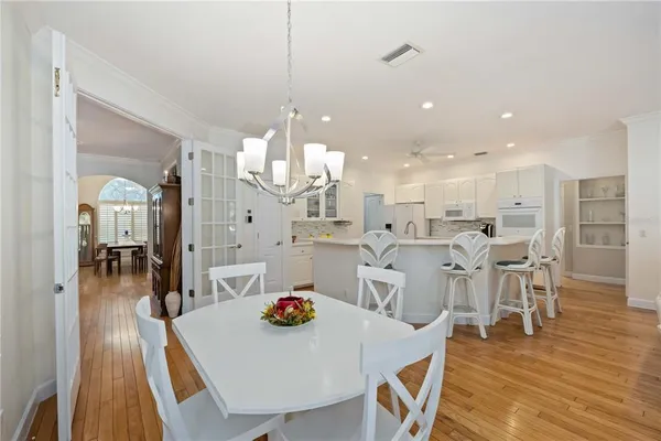 a large dining space with furniture and wooden floor