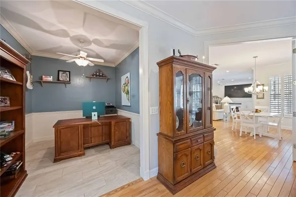 a living room with furniture a flat screen tv and wooden floor