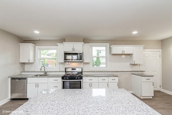 170-180 America Street Fall River, MA 02721 - Photo 11 of 40 a kitchen with stainless steel appliances kitchen island granite countertop a sink and cabinets