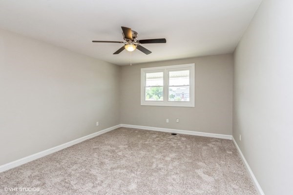 170-180 America Street Fall River, MA 02721 - Photo 16 of 40 an empty room with a window and a ceiling fan