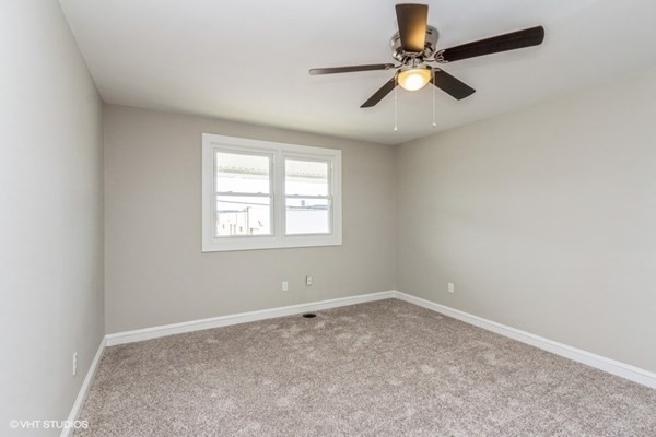 170-180 America Street Fall River, MA 02721 - Photo 17 of 40 an empty room with windows and fan